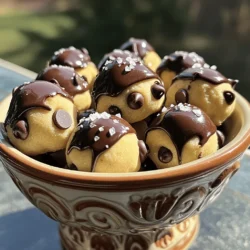To make the best chocolate chip cookie dough bites, you need these key ingredients: - 1 cup all-purpose flour - 1/2 cup unsalted butter, softened - 1/4 cup granulated sugar - 1/4 cup brown sugar, packed - 1 teaspoon vanilla extract - 1/2 teaspoon salt - 1/2 cup semi-sweet chocolate chips - 2 tablespoons milk (or dairy-free alternative) These ingredients create a rich and creamy cookie dough that is both tasty and satisfying. You can customize your cookie dough bites by adding these fun extras: - 1/4 cup chopped nuts - 1/4 cup mini marshmallows - 1/4 cup dried fruit These add-ins can bring new textures and flavors to your bites. Feel free to mix and match! If you have dietary needs, here are some easy swaps: - Use gluten-free flour for a gluten-free option. - Swap butter with coconut oil for a dairy-free version. - Replace granulated sugar with coconut sugar for a healthier choice. These substitutions let everyone enjoy these cookie dough bites. They can fit into different diets without losing flavor or fun! For the complete recipe to make these delightful bites, check out the Full Recipe. Making chocolate chip cookie dough bites is simple and fun. You need just a few steps. Start by gathering your ingredients. You will use flour, butter, sugars, vanilla, salt, chocolate chips, and milk. Once you have everything, you can begin the process. 1. In a mixing bowl, cream together the softened butter, granulated sugar, and brown sugar until light and fluffy. 2. Add the vanilla extract and stir well to combine. 3. Gradually mix in the flour and salt. Make sure there are no dry pockets. 4. If your dough is too crumbly, add milk a tablespoon at a time. This helps make the dough smooth. 5. Gently fold in the semi-sweet chocolate chips and chopped nuts if you want them. 6. Use a spoon to scoop small portions of dough. Roll them into balls, about one inch wide. 7. Place your cookie dough balls on a parchment-lined baking sheet. 8. Refrigerate them for at least 30 minutes. This helps firm up the cookie dough bites. For the best texture, keep these tips in mind: - Make sure your butter is softened but not melted. This helps create a light and fluffy mix. - Mix the flour slowly. Too much mixing can make the dough tough. - Adjust the milk as needed. A smooth dough is key for rolling. - If you want a chewier bite, add a bit more brown sugar. With these steps and tips, you can create delicious chocolate chip cookie dough bites. For the full recipe, check out the details provided earlier. Happy baking! Store your chocolate chip cookie dough bites in an airtight container. Keeping them in the fridge helps them stay fresh. If you want to keep them longer, you can freeze them. Just place them in a freezer bag, and they will last for up to three months. When serving, arrange the bites on a nice plate or in a decorative bowl. This makes them look so much more inviting. You can sprinkle a little sea salt on top to enhance the flavor. If you want to impress, drizzle melted chocolate over them just before serving. One common mistake is not measuring the flour correctly. Too much flour can make the dough dry. Always spoon and level the flour when measuring. Another mistake is skipping the refrigeration step. Chilling the dough helps it hold its shape when you roll it. Lastly, avoid overmixing the dough after adding the flour. This can make the bites tough. Mix just until you see no dry flour left. To make your cookie dough bites pop, think about color. You can add colorful sprinkles or nuts to the top. This adds a fun visual element. Also, using different types of chocolate can change the flavor. Try mixing dark chocolate chips with milk chocolate for a richer taste. You can even add a hint of sea salt on top for a sweet and salty contrast. For a fun twist, serve them with a small scoop of ice cream. It adds a creamy texture that pairs well with the bites. You can find the full recipe for these chocolate chip cookie dough bites and explore various serving ideas. {{image_2}} You can play with flavors in your cookie dough bites. Try adding peanut butter for a nutty twist. Simply mix in 1/4 cup of creamy peanut butter when you combine the butter and sugars. If you love mint, add 1/2 teaspoon of mint extract. This gives your bites a refreshing kick. You can even use different types of chocolate chips, like dark or white chocolate, to keep things exciting. Making healthy versions of cookie dough bites is easy. For a vegan option, swap the butter for coconut oil and use a plant-based milk. You can also replace the all-purpose flour with oat flour. This makes the bites gluten-free. Always check that your chocolate chips are dairy-free when going vegan. These swaps allow everyone to enjoy cookie dough bites without worry. Serve your cookie dough bites in fun ways. Use a decorative bowl to make them pop. You can sprinkle a little sea salt on top for an extra flavor boost. For a fancy touch, drizzle melted chocolate over the bites before serving. You can also use colorful cupcake liners to make each bite feel special. These small details make your cookie dough bites more appealing and fun to share. For the full recipe and details, check out the [Full Recipe]. To keep your chocolate chip cookie dough bites fresh, store them in an airtight container. This helps prevent them from drying out. You can place parchment paper between layers of bites to avoid sticking. If you plan to eat them later, refrigeration is best. Make sure the container is sealed well to keep out air. Homemade cookie dough bites last about one week in the fridge. If you want them longer, freezing is a great option. Place the bites on a baking sheet and freeze them for about an hour. Once firm, transfer them to a freezer-safe bag. They can last up to three months in the freezer. Just remember to label the bag with the date. When you’re ready to enjoy your frozen cookie dough bites, thaw them in the fridge overnight. If you want to eat them warm, you can microwave them for about 10-15 seconds. This softens them without cooking them. Enjoy them straight from the fridge or after a quick heat-up for a sweet treat anytime! For the full recipe, refer to the original instructions above. Yes, you can eat cookie dough bites raw. The dough is safe because we use heat-treated flour. This means you won’t get sick from eating it. It’s a fun treat to enjoy without baking. Just remember, moderation is key! You can find pre-made chocolate chip cookie dough bites at many grocery stores. Look in the frozen or refrigerated sections. Some brands even sell them in the snack aisle. If you want a quick treat, these are great options. Each bite has about 80 calories. They contain 4 grams of fat, 10 grams of carbs, and 1 gram of protein. The exact numbers may vary based on your ingredients. For the full recipe, check the details online or on the package. Homemade cookie dough bites last about one week in the fridge. You can store them in an airtight container. If you want them to last longer, freeze them. They can stay fresh for up to three months in the freezer. Just let them thaw before enjoying! You learned about the key ingredients for chocolate chip cookie dough bites. I offered recipes and options for dietary needs. You saw step-by-step instructions for making them at home. I shared storage tips and ways to avoid common mistakes. The post also explored flavors and creative serving ideas. Cookie dough bites are fun and easy to make. Now, you can enjoy them any way you like!