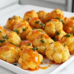To make Buffalo cauliflower bites in an air fryer, gather these ingredients: - Cauliflower florets - 1 cup all-purpose flour (or gluten-free flour) - 1 teaspoon garlic powder - 1 teaspoon onion powder - 1 teaspoon smoked paprika - 1/2 teaspoon cayenne pepper (adjust for spiciness) - 1/2 teaspoon salt - 1 cup water (adjust as needed for consistency) - 1/2 cup buffalo sauce (store-bought or homemade) - 1 tablespoon melted coconut oil or olive oil - Fresh parsley, chopped (for garnish) These ingredients create a flavorful batter that coats the cauliflower. The spices bring heat and depth to every bite, while the buffalo sauce adds that classic zing. You can easily adjust the cayenne pepper to control how spicy you want the bites to be. Fresh parsley adds a nice touch of color and flavor when you serve the bites. To make this dish, you need a mix of dry and liquid ingredients. The batter must be thick enough to coat the cauliflower but not too heavy. Adding water slowly helps you get the right texture. Ensure you have all the ingredients ready before you start cooking. This way, the process flows smoothly. The ingredient list is simple but provides a big punch in flavor. Enjoy the crispiness and the spicy kick of these Buffalo cauliflower bites! Start by cutting the cauliflower into small florets. Aim for pieces that are about the same size for even cooking. Remove the leaves and stem. Rinse the florets under cold water to clean them. Next, I make the batter. In a large bowl, combine 1 cup of all-purpose flour, 1 teaspoon of garlic powder, 1 teaspoon of onion powder, 1 teaspoon of smoked paprika, 1/2 teaspoon of cayenne pepper, and 1/2 teaspoon of salt. Whisk these dry ingredients together well. Gradually add 1 cup of water, mixing until a smooth batter forms. The batter should be thick enough to coat the florets but not too heavy. Adjust the water as needed. Dip each cauliflower floret into the batter. Make sure each piece is evenly coated. Allow any excess batter to drip off before cooking. Preheat your air fryer to 400°F (200°C) for about 5 minutes. This step is key for getting crispy bites. Once preheated, arrange the battered cauliflower florets in a single layer in the air fryer basket. Be sure they do not touch, as this can make them soggy. If needed, cook in batches. Cook the florets for 10-12 minutes. Halfway through, shake the basket gently to help them cook evenly. Look for a golden brown color to know they are ready. After cooking, transfer the florets to a bowl. Add 1/2 cup of buffalo sauce and 1 tablespoon of melted coconut oil. Toss everything together until the cauliflower is well coated. Return the sauced cauliflower bites to the air fryer. Cook for an additional 2-3 minutes. This step helps the sauce set and adds a nice crisp. Carefully remove the buffalo cauliflower bites from the air fryer. Garnish with chopped parsley before serving. Enjoy these crispy treats hot! To get that perfect crispy bite, start with the right batter. Your batter should be thick, but not too heavy. This helps the coating stick well to the cauliflower. If you need a bit more crunch, add a touch more flour. Adjust the water as needed to keep it thick enough. When using your air fryer, preheat it to 400°F (200°C). This step makes a big difference and helps cook the bites evenly. Place the coated florets in a single layer in the basket. Avoid overcrowding them. This allows hot air to circulate and gives you that crispy texture. Shake the basket halfway through cooking, about 10 to 12 minutes. This movement helps all sides get golden brown. After cooking, toss the bites in your buffalo sauce and melted oil for added flavor. Then, cook them for another 2 to 3 minutes to set the sauce and crisp them up even more. Presentation matters! Serve your buffalo cauliflower bites on a nice platter. You can place them next to a bowl of ranch or blue cheese dressing for dipping. This adds a nice touch and makes them more fun to eat. To make your dish pop, sprinkle fresh parsley on top. The green adds color and freshness. You can also add celery sticks or carrot slices on the side. These crunchy veggies pair well and give a nice balance to the spicy bites. Enjoy your tasty treat! {{image_2}} You can change up the flavor of your buffalo cauliflower bites easily. If you like heat, add more cayenne or hot sauce. This will give your bites a spicy kick. You can also try different spice blends. For a smoky flavor, add smoked paprika. If you want something zesty, use lemon pepper or taco seasoning. Mix and match to find your favorite blend! If you need a gluten-free version, swap all-purpose flour for gluten-free flour. Make sure to check the label for any hidden gluten. You can also use almond flour or chickpea flour. These options add great taste and texture. For a vegan-friendly dish, skip the melted coconut oil and use a little vegetable broth instead. Toss the cauliflower in the buffalo sauce without any oil for a lighter option. Enjoy these bites with your favorite dip, and you won’t miss the dairy at all! To store leftover buffalo cauliflower bites, let them cool first. Place them in an airtight container. You can keep them in the fridge for up to three days. When reheating, use the air fryer. Set it to 350°F (175°C) for about 5-7 minutes. This keeps them crispy and tasty. Avoid using a microwave, as it can make them soggy. For freezing uncooked bites, follow the recipe steps until the batter stage. Place the coated florets on a baking sheet in a single layer. Freeze them for about two hours. Once frozen, transfer them to a freezer bag. This way, they stay fresh for up to three months. To cook frozen bites, do not thaw them. Preheat your air fryer to 400°F (200°C) and cook for 12-15 minutes. Shake the basket halfway through for even cooking. Enjoy your crispy treat straight from the freezer! Buffalo cauliflower bites take about 12 to 15 minutes to cook in an air fryer. Start by cooking them for 10 to 12 minutes at 400°F (200°C). Shake the basket halfway through for even cooking. After that, toss them in buffalo sauce and cook for another 2 to 3 minutes. This makes them crispy and tasty! Yes, you can make buffalo cauliflower bites without flour. You can use chickpea flour or almond flour instead. These options will still give a good coating and add a nice flavor. You could also use a batter made from blended nuts or seeds. Just ensure it has a thick consistency to coat the florets. If you want a different flavor, you can use barbecue sauce or sriracha. Both will add a nice kick. For a milder taste, try mixing hot sauce with honey or maple syrup. You can also create a homemade sauce with spices and vinegar for a personal touch! In this article, I covered how to make tasty buffalo cauliflower bites. We looked at needed ingredients, from cauliflower to spices. The steps for preparation and cooking ensure a great crunch. I shared tips for crispiness and serving ideas. You can also explore variations and learn proper storage methods. Buffalo cauliflower bites are a fun, healthy snack or meal. Enjoy experimenting with flavors and techniques to make this dish your own.