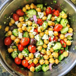 To make this salad, you need some key items. Here’s what you will need: - 1 can (15 oz) chickpeas, rinsed and drained - 1 cup cherry tomatoes, halved - 1 cucumber, diced - 1/2 red onion, finely chopped - 1/3 cup Kalamata olives, pitted and sliced - 1 cup crumbled feta cheese - 1/4 cup fresh parsley, chopped - 1 teaspoon dried oregano - 3 tablespoons olive oil - 2 tablespoons lemon juice - Salt and pepper to taste These ingredients provide a mix of textures and flavors. The chickpeas add protein and fiber. The cherry tomatoes and cucumber give a fresh crunch. Feta cheese brings a creamy, salty touch. You can also add a few optional items to enhance the taste. Consider these: - Red bell pepper, diced - Avocado, diced - Fresh mint, chopped - Capers, rinsed - Hot pepper flakes for heat These extras can change the salad’s flavor profile. They can make it zestier or creamier, depending on your choice. Each ingredient in this salad brings health benefits. Here’s a quick look: - Chickpeas: Packed with protein and fiber. They help keep you full. - Tomatoes: High in vitamins C and K, plus lycopene, which is great for your heart. - Cucumbers: Low in calories and hydrating, perfect for warm days. - Feta Cheese: Provides calcium and adds rich flavor. - Olive Oil: A healthy fat that supports heart health. - Lemon Juice: Packed with vitamin C and adds a bright flavor. This salad not only tastes great but also supports your health. Enjoy it as a light meal or a side dish! To start your Mediterranean chickpea feta salad, gather all your ingredients. You will need one can of chickpeas. Rinse them well and drain the water. Then, take one cup of cherry tomatoes and cut them in half. Next, chop one cucumber into small pieces. For a bit of bite, finely chop half a red onion. Slice a third of a cup of Kalamata olives, which add great flavor. Finally, crumble one cup of feta cheese and chop a quarter cup of fresh parsley. In a large bowl, mix the chickpeas, tomatoes, cucumber, red onion, and olives. Gently add the crumbled feta and parsley. Be careful not to break the feta too much while mixing. This will keep the texture nice. Next, make the dressing in a small bowl. Whisk together three tablespoons of olive oil, two tablespoons of lemon juice, one teaspoon of dried oregano, and some salt and pepper. Pour this dressing over the salad mix. Toss everything lightly to coat. Let the salad sit for ten minutes. This helps the flavors blend well. Taste it to see if you need more salt or pepper. You can serve it chilled or at room temperature. Enjoy! To make a great Mediterranean chickpea feta salad, select the best ingredients. Look for firm cherry tomatoes. They should feel slightly soft but not mushy. Choose a cucumber that is smooth and dark green. This means it is fresh and crisp. For red onions, pick ones that are firm and have a rich color. Kalamata olives should look shiny and plump. For parsley, go for bright green leaves with no yellow spots. Fresh ingredients boost flavor and make your dish shine. One common mistake is not rinsing chickpeas well. Rinse them to remove excess salt and canning liquid. This helps in keeping the salad fresh. Another mistake is cutting vegetables too small. Keep them slightly chunky for a better bite. Don't forget to taste your salad before serving. Adjust salt and pepper based on your taste. Lastly, let your salad sit for about 10 minutes before serving. This lets the flavors blend nicely. You can add extra flavor to your salad in many ways. Try mixing in some chopped bell peppers for a sweet crunch. A sprinkle of red pepper flakes can add a little heat. Fresh herbs like mint or dill can elevate the taste. If you want a creamier salad, mix in some avocado. For a tangy kick, a splash of balsamic vinegar works great. Experiment with these ideas and find your favorite combo! {{image_2}} If you want a gluten-free dish, this salad is perfect. All the main ingredients are gluten-free. To make it vegan, you can swap feta cheese. Try using vegan feta or omit cheese altogether. The salad still tastes great without it. You can change ingredients based on what's in season. In summer, add fresh bell peppers or radishes for crunch. In the fall, roasted butternut squash adds a sweet touch. Experiment with seasonal fruits like peaches or strawberries for a twist. The dressing can change the salad's taste. For a creamier option, mix in some yogurt or tahini. If you like a spicy kick, add a bit of harissa or sriracha. For a sweet touch, try honey or maple syrup in the dressing. Adjust these flavors to fit your mood or meal. To keep your Mediterranean chickpea feta salad fresh, store it in an airtight container. This prevents moisture loss and keeps the flavors intact. I like to use glass containers since they don't stain or retain odors. Make sure to keep the salad chilled in the fridge. This salad stays fresh for about 3 to 5 days in the fridge. The veggies hold up well, but the feta may start to lose its texture after a couple of days. Always check for any off smells or changes in color before eating leftovers. Freezing this salad is not the best idea. The texture of the chickpeas and veggies will change once thawed. If you must freeze it, consider leaving out the feta. You can add it back in after thawing for a fresher taste. Yes, you can use canned chickpeas. They save time and effort. Just rinse and drain them. Canned chickpeas are soft and ready to eat. This makes your salad quick and easy to prepare. If you need a substitute for feta, try goat cheese or ricotta. Both have a creamy texture. You can also use tofu for a vegan option. Crumble it to mimic feta's texture. Each choice will change the taste a bit but still keep it tasty. To add some spice, consider using jalapeños or crushed red pepper flakes. You can also add a dash of hot sauce to the dressing. Another option is to mix in some spicy olives. This way, you can enjoy a zesty kick in every bite. Yes, this salad is very healthy! It is full of fiber, protein, and vitamins. Chickpeas provide great protein, while veggies add nutrients. Feta adds calcium, and olive oil gives healthy fats. This dish is perfect for a light meal or a side dish. This article covered the essential and optional ingredients for a delicious Mediterranean Chickpea Feta Salad. I shared clear steps for preparation and mixing, plus tips for selecting fresh items. We explored variations for different diets and the best storage methods. In closing, this salad is not just tasty; it’s also healthy and easy to customize. Enjoy creating this dish and make it your own! Your meals can be fresh, fun, and good for you.