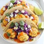 - 1 medium head of cauliflower, cut into florets - 1 cup all-purpose flour - 1 teaspoon garlic powder - 1 teaspoon onion powder - 1 teaspoon smoked paprika - 1 teaspoon cayenne pepper (adjust for spice level) - 1 cup buttermilk (or plant-based milk for a vegan option) - 1 cup buffalo sauce - 8 small corn tortillas - 1 cup shredded purple cabbage - ½ cup crumbled feta cheese (or a vegan substitute) - Fresh cilantro for garnish - Lime wedges for serving - Salt and pepper to taste You can swap the all-purpose flour for gluten-free flour if needed. If you want a vegan dish, use plant-based milk instead of buttermilk. For a dairy-free taco, replace feta cheese with a vegan cheese or omit it entirely. If buffalo sauce is too spicy, try a milder sauce. You can also use lettuce instead of cabbage for a different crunch. Always choose a firm cauliflower head with tight florets for the best taste. Fresh ingredients make a big difference in flavor. Store your cauliflower in a cool, dry place until you’re ready to cook. For the tortillas, buy fresh ones from a local store or make your own for the best texture. Fresh cilantro should look vibrant and green; avoid any yellow or wilted leaves. Start by preheating your oven to 450°F (230°C). Line a baking sheet with parchment paper for easy cleanup. Next, cut one medium head of cauliflower into bite-sized florets. This helps the cauliflower cook evenly. In a mixing bowl, combine 1 cup of all-purpose flour, 1 teaspoon of garlic powder, 1 teaspoon of onion powder, 1 teaspoon of smoked paprika, and 1 teaspoon of cayenne pepper. Add salt and pepper to taste. In another bowl, pour 1 cup of buttermilk. Dip each floret in the buttermilk, letting the extra drip off. Then, coat each piece with the flour mixture. Place the coated florets on the baking sheet. Bake the cauliflower for 20-25 minutes. Flip them halfway through for even cooking. You want them golden brown and crispy. After baking, toss the cauliflower in a bowl with 1 cup of buffalo sauce. Make sure every piece is well coated. Return the sauced cauliflower to the baking sheet and bake again for 5-10 minutes. This step helps the sauce stick better and adds flavor. While the cauliflower is baking, warm 8 small corn tortillas in a dry skillet over medium heat. Heat them for about 30 seconds on each side. This makes them soft and pliable. Once the cauliflower is ready, start assembling your tacos. Place a generous amount of crispy buffalo cauliflower on each tortilla. Top them with 1 cup of shredded purple cabbage and ½ cup of crumbled feta cheese. Add fresh cilantro for a pop of color and flavor. Serve your tacos with lime wedges on the side for an extra zing. Enjoy every bite! To make your buffalo cauliflower extra crispy, coat it well. After dipping in buttermilk, ensure you cover each floret in the flour mix. This layer traps the moisture and creates a crunchy shell. Bake the cauliflower at a high temperature, around 450°F (230°C). Flip them halfway through cooking for even crispiness. If you want an even crunchier texture, consider a quick fry in hot oil after baking. Buffalo sauce can be hot, so adjust it to your taste. If you prefer milder tacos, use less cayenne pepper in the flour mix. You can also mix in a little honey or maple syrup with the buffalo sauce to balance the heat. For a spicy kick, add more cayenne or opt for a hotter sauce. Taste as you go, and find your perfect balance. You can prepare the cauliflower in advance. After coating it in the flour mix, place it on a baking sheet and cover it with plastic wrap. Store it in the fridge for up to 24 hours. When you're ready, just bake it as directed. For the best flavor, toss it in buffalo sauce right before serving. This keeps it fresh and tasty! {{image_2}} To make these tacos vegan, swap buttermilk for plant-based milk. You can use almond or oat milk. Replace feta cheese with a vegan option like cashew cheese or tofu. These changes keep the flavor while making it plant-based and delicious. Feel free to get creative with toppings. Instead of purple cabbage, use shredded lettuce or diced tomatoes. Avocado or guacamole adds creaminess. You could even add pickled onions for a tangy kick. The fun is in mixing flavors you love. If buffalo sauce isn’t your favorite, try other sauces. BBQ sauce offers a sweet twist. For a milder flavor, ranch dressing works well. You could also mix hot sauce with a bit of honey for a sweet and spicy sauce. Explore different options to find your favorite! You can store leftover tacos in the fridge. Place them in an airtight container. They stay fresh for up to three days. If you keep the toppings separate, they will hold up better. This helps maintain the crispiness of the cauliflower. Freezing is a great option if you want to keep them longer. To freeze, wrap individual tacos tightly in plastic wrap. Then, place them in a freezer-safe bag. They can last for about one month. When you're ready to eat, thaw them overnight in the fridge. Reheat in the oven for the best texture. Preheat your oven to 350°F (175°C). Place the tacos on a baking sheet for about 10-15 minutes. This keeps the cauliflower crispy. You can also use a microwave, but the texture may suffer. If you use the microwave, heat in short bursts to avoid sogginess. Yes, you can make this recipe gluten-free. Use gluten-free flour instead of all-purpose flour. Brands like almond flour or chickpea flour work well. Just make sure your buffalo sauce is also gluten-free. To store leftover tacos, place them in an airtight container. Keep them in the fridge for up to three days. When ready to eat, reheat them in the oven for the best crispiness. If you need a substitute for buttermilk, you have options. You can mix one cup of plant-based milk with one tablespoon of vinegar or lemon juice. Let it sit for five minutes. This will give you a similar tangy flavor. Absolutely! You can switch the buffalo sauce with other sauces. Try barbecue sauce for a sweet twist or sriracha for extra heat. Experiment with different flavors to find your favorite. Each taco has about 150-200 calories, depending on toppings. This can vary based on the type of cheese or sauce you use. For a more accurate count, check specific brands or ingredients you choose. This blog post covered everything you need for Crispy Buffalo Cauliflower Tacos. We reviewed ingredients, preparation steps, and tips to maximize freshness. I shared ways to make this dish your own and how to store leftovers. In the end, enjoy these tasty tacos. They are fun, easy, and great for everyone. Experiment with flavors and toppings to make them special. Happy cooking!