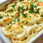 To make a delicious Alfredo spaghetti bake, gather these key items: - 8 oz spaghetti - 2 tablespoons olive oil - 3 cloves garlic, minced - 2 cups heavy cream - 1 cup grated Parmesan cheese - 1 cup shredded mozzarella cheese - 1 teaspoon garlic powder - 1 teaspoon Italian seasoning - Salt and pepper to taste - 1 cup cooked chicken, diced (optional) - Fresh parsley, chopped (for garnish) These ingredients work well together to create a creamy and cheesy dish. The garlic adds a nice touch of flavor, while the cheeses give it a rich taste. You can change the dish by adding some optional items: - 1 cup cooked broccoli or spinach for extra nutrition - 1 cup sautéed mushrooms for earthy flavor - 1 teaspoon red pepper flakes for some heat - Other cooked meats like shrimp or sausage Mixing in these ingredients can make your Alfredo spaghetti bake unique. You can customize it to your taste. If you need to swap some ingredients, here are some options: - Use whole wheat spaghetti for a healthier choice - Swap heavy cream with half-and-half for a lighter sauce - Use nutritional yeast instead of cheese for a vegan option - Use garlic powder instead of fresh garlic if you’re short on time These substitutions help you adapt the recipe to fit your needs. They also ensure you can still enjoy a tasty meal, no matter what. Start by preheating your oven to 350°F (175°C). This gets the oven ready for baking. Next, cook 8 oz of spaghetti in boiling water. Follow the package instructions until the pasta is al dente. Drain the spaghetti and set it aside. In a large skillet, pour in 2 tablespoons of olive oil. Heat the oil over medium heat. Add 3 cloves of minced garlic and sauté for about 1 minute. You want the garlic to smell nice but not burn. Lower the heat and pour in 2 cups of heavy cream. Warm the cream gently. Gradually add 1 cup of grated Parmesan cheese and stir until it melts. This makes a smooth sauce. Now, season your sauce with 1 teaspoon of garlic powder and 1 teaspoon of Italian seasoning. Add salt and pepper to taste. If you like, fold in 1 cup of diced cooked chicken. This adds protein and flavor. In a large bowl, mix the cooked spaghetti with the Alfredo sauce. Make sure every strand of pasta is well coated. Transfer the mixture to a greased baking dish. For the top, sprinkle 1 cup of shredded mozzarella cheese evenly. Bake the dish in your preheated oven for 25-30 minutes. You want the cheese to be bubbly and slightly golden. Once baked, take it out and let it cool for about 5 minutes. Garnish with fresh chopped parsley before serving. Enjoy your creamy Alfredo spaghetti bake! To make the creamiest Alfredo sauce, use heavy cream. It gives you a rich texture. Heat the cream gently so it warms up but doesn’t boil. After that, add grated Parmesan cheese slowly. Stir it in until it melts fully. This step is key to a smooth sauce. If you want a hint of flavor, sprinkle in some garlic powder and Italian seasoning. Taste it and adjust the salt and pepper as needed. Cook your spaghetti just until al dente. This means it should have a slight bite. Follow the package instructions closely for timing. Drain the spaghetti right away to stop the cooking. If you let it sit in hot water, it will get too soft. Mixing the hot pasta with your Alfredo sauce helps keep it warm. This also allows the sauce to cling better to the noodles. Alfredo spaghetti bake is great on its own, but you can make it even better. Serve it with a crisp salad for freshness. A simple side of garlic bread adds a nice touch. For drinks, a light white wine pairs well with the creamy dish. If you want a pop of color, sprinkle fresh parsley on top before serving. It not only looks nice but adds a hint of flavor too. {{image_2}} You can easily make a vegetarian Alfredo spaghetti bake. Just skip the chicken. Use the same creamy sauce and pasta. This dish remains rich and filling without meat. You may add more cheese for extra flavor. Try using feta or goat cheese for a twist. Adding vegetables boosts the nutrition of your bake. Spinach, broccoli, or bell peppers work great. Sauté them with the garlic to bring out the flavors. Mix them into the pasta and sauce. This adds color and makes the dish healthier. You can even use frozen veggies if you're in a hurry. For a seafood version, swap the chicken for shrimp or crab. Cook the seafood until just done, then mix it in. The combination of seafood and creamy sauce is so flavorful. You may also add some lemon zest for a fresh taste. This variation is perfect for special occasions or seafood lovers. To store leftovers, let the dish cool down first. Use an airtight container. Place the spaghetti bake in it and seal tightly. This keeps moisture in and prevents drying out. You can store it in the fridge for up to three days. When you want to eat leftovers, take them out of the fridge. Preheat your oven to 350°F (175°C). Place the spaghetti bake in an oven-safe dish. Cover it with foil to keep it from drying out. Heat for about 20 minutes. You can also use the microwave. Heat on medium for 2-3 minutes, stirring halfway through. If you want to freeze your Alfredo spaghetti bake, cool it completely first. Use a freezer-safe container. You can also use freezer bags. Remove as much air as you can before sealing. This helps prevent freezer burn. It will last for up to three months in the freezer. When ready to eat, thaw it in the fridge overnight before reheating. Yes, you can make this dish ahead of time. Prepare the spaghetti and sauce, then combine them. Place the mixture in a baking dish. Cover it and store it in the fridge. You can bake it later when you're ready to serve. It’s a great way to save time on busy days. This dish pairs well with many sides. Here are a few ideas: - Garlic bread - A fresh green salad - Steamed vegetables - Roasted Brussels sprouts These sides add color and balance to the meal. Alfredo Spaghetti Bake lasts about 3 to 5 days in the fridge. Make sure to store it in an airtight container. Always check for any signs of spoilage before eating. If it smells off or looks strange, it’s best to throw it away. Yes, you can use store-bought Alfredo sauce. It saves time and still tastes good. Just heat it up and mix it with the cooked spaghetti. You can add your own spices to enhance the flavor. However, making your own sauce gives it a fresher taste. This blog post shared the key steps to make a great Alfredo spaghetti bake. We covered ingredients, cooking tips, and fun variations. You can use simple swaps or add veggies to boost nutrition. With the right method, you’ll have a creamy sauce and perfectly cooked dish every time. Store any leftovers in the fridge or freezer for easy meals. Enjoy making this delicious recipe your way! It’s time to get in the kitchen and start cooking!